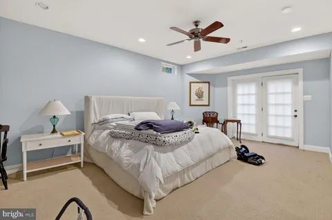 a room with furniture pool table and windows