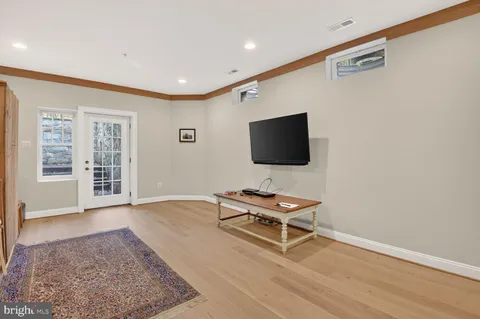 a living room with furniture pool table and flat screen tv
