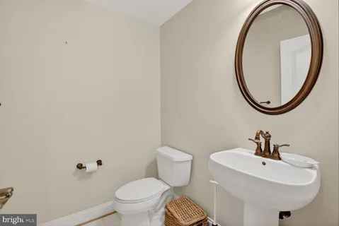 a room with lots of wooden furniture and a chandelier