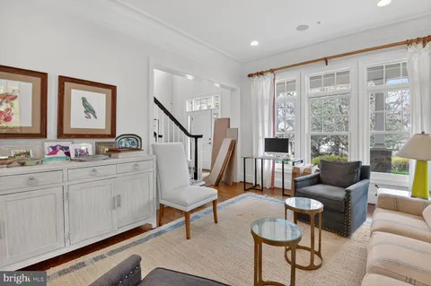 a kitchen with stainless steel appliances white cabinets and a window