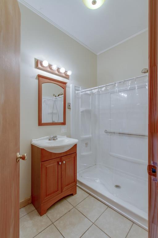 4314 Kinneys Road Springfield, TN 37172 - Photo 14 of 28 a bathroom with a granite countertop sink a mirror and a shower