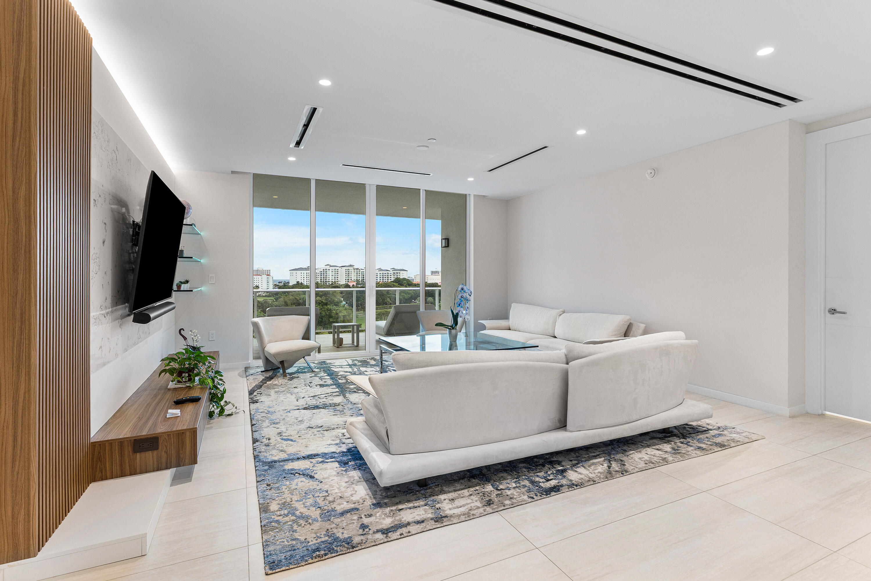 200 Southeast Mizner Boulevard, Unit 707 Boca Raton, FL 33432 - Photo 11 of 119 a living room with furniture a flat screen tv and a large window