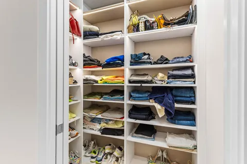 a kitchen with stainless steel appliances a dining table chairs and wooden floor