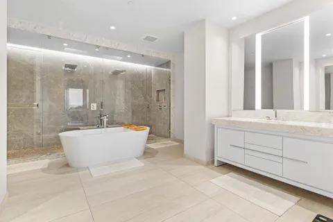 a view of swimming pool with outdoor seating and house in the background