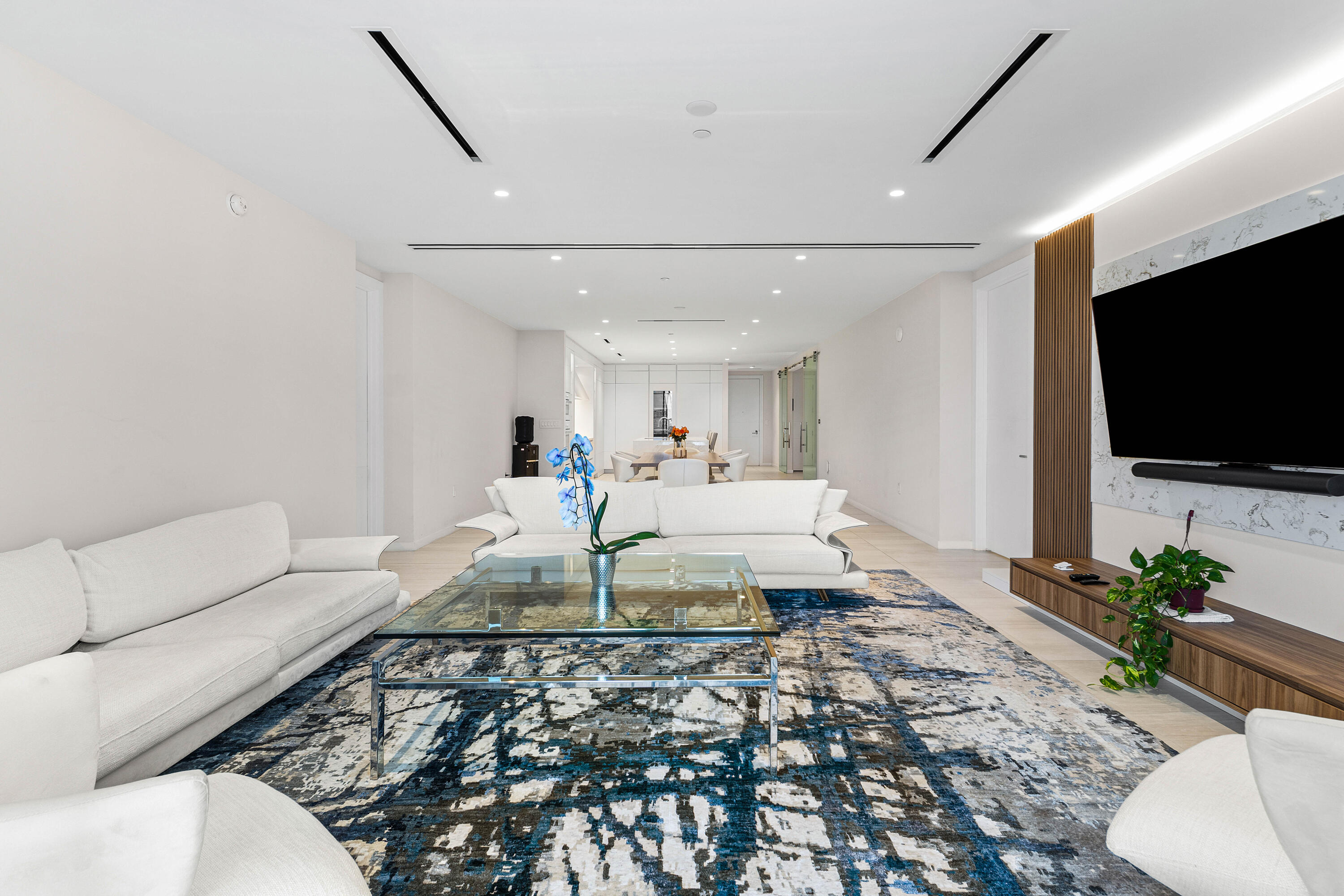 200 Southeast Mizner Boulevard, Unit 707 Boca Raton, FL 33432 - Photo 9 of 119 a living room with furniture and a flat screen tv