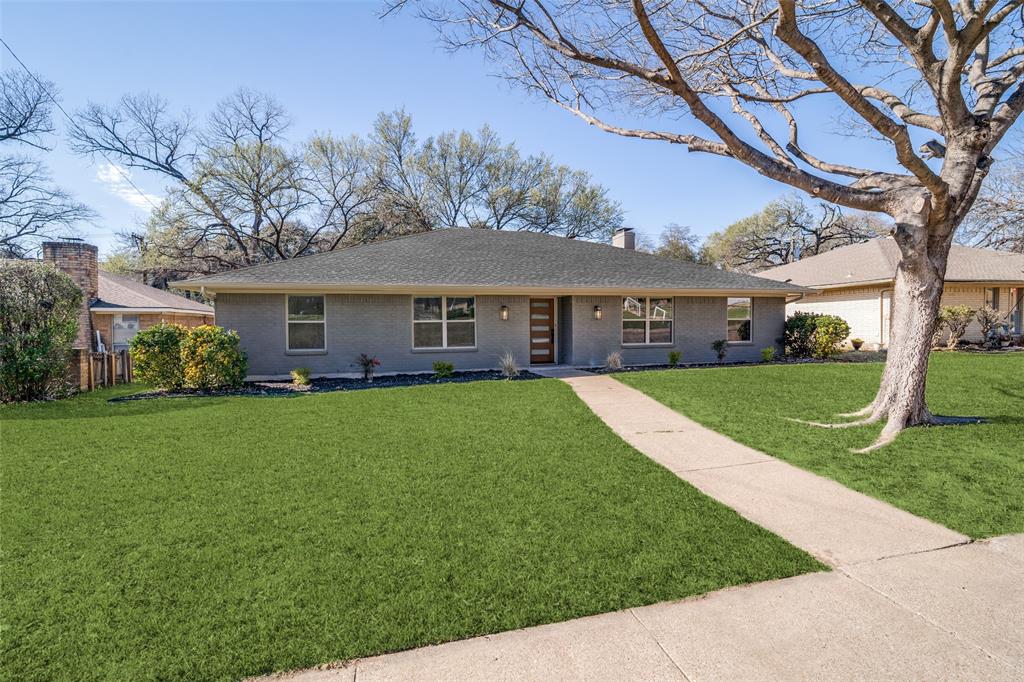 a view of house that has a yard