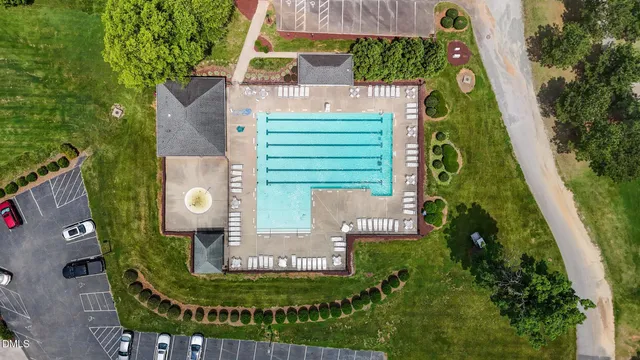 an aerial view of a backyard with swimming pool
