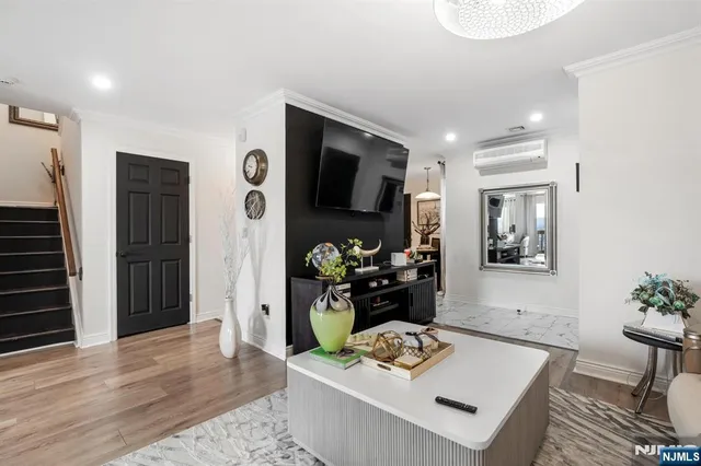 a bedroom with furniture a fireplace and potted plants