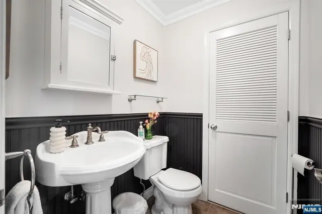 a bedroom with a bed and a flat tv screen on dresser