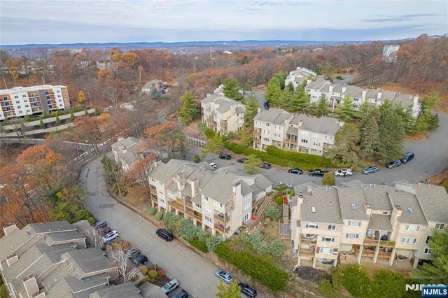 an aerial view of multiple houses with a yard