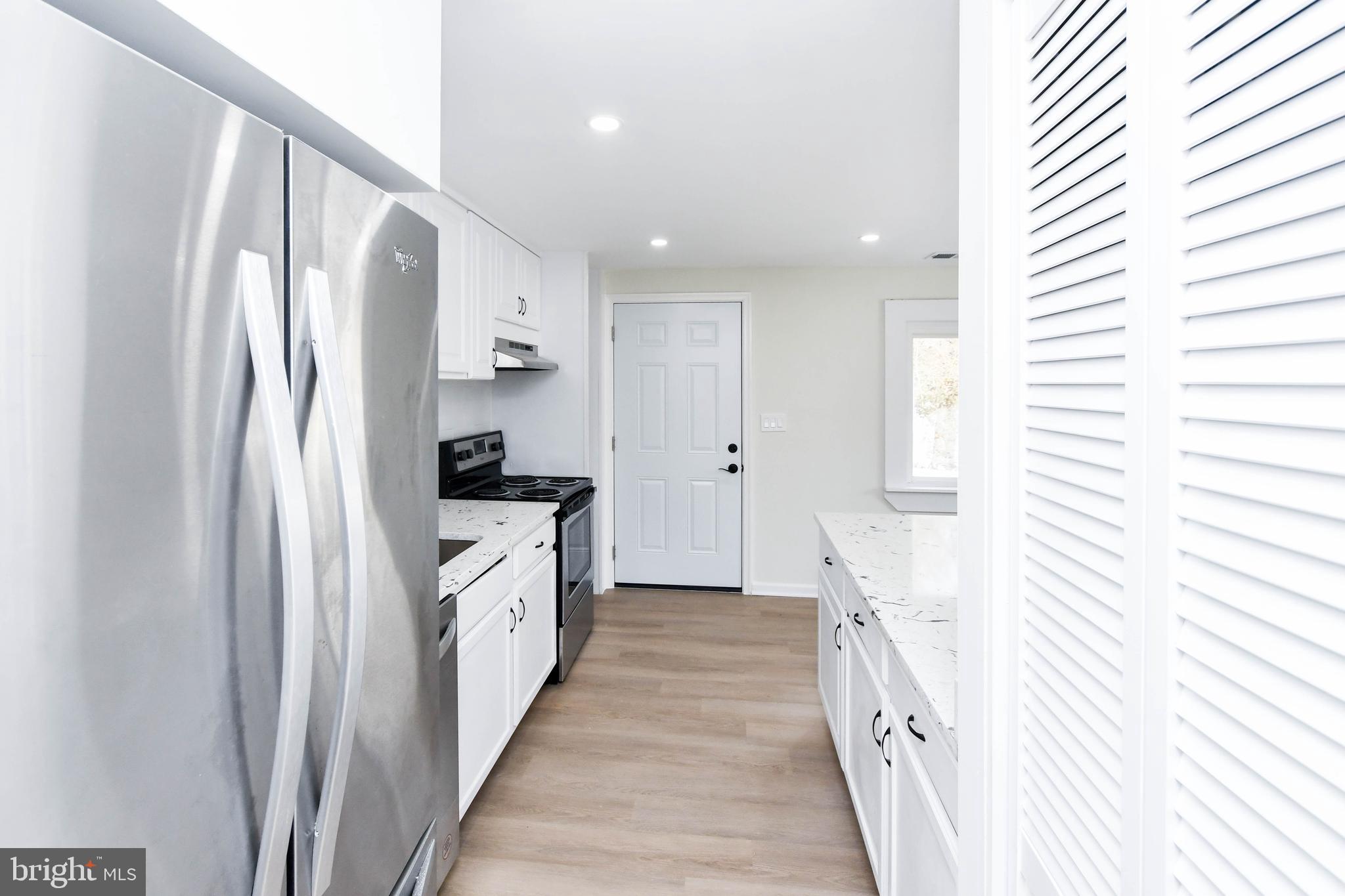 8130 Sheriff Road Landover, MD 20785 - Photo 11 of 36 a kitchen with stainless steel appliances a refrigerator and a window