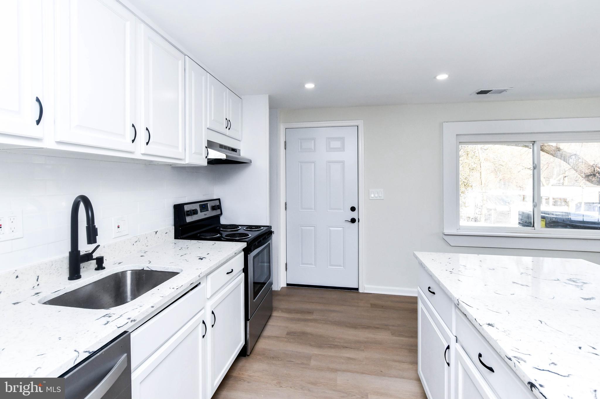 8130 Sheriff Road Landover, MD 20785 - Photo 12 of 36 a kitchen with a sink a stove and cabinets