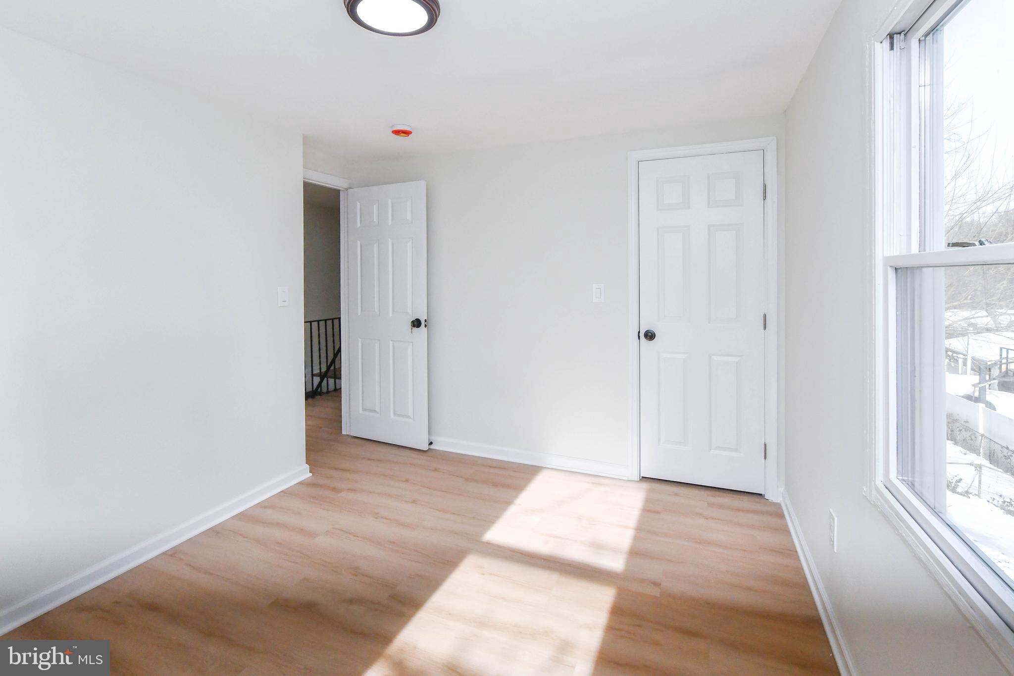 8130 Sheriff Road Landover, MD 20785 - Photo 26 of 36 a view of an empty room with wooden floor and a window