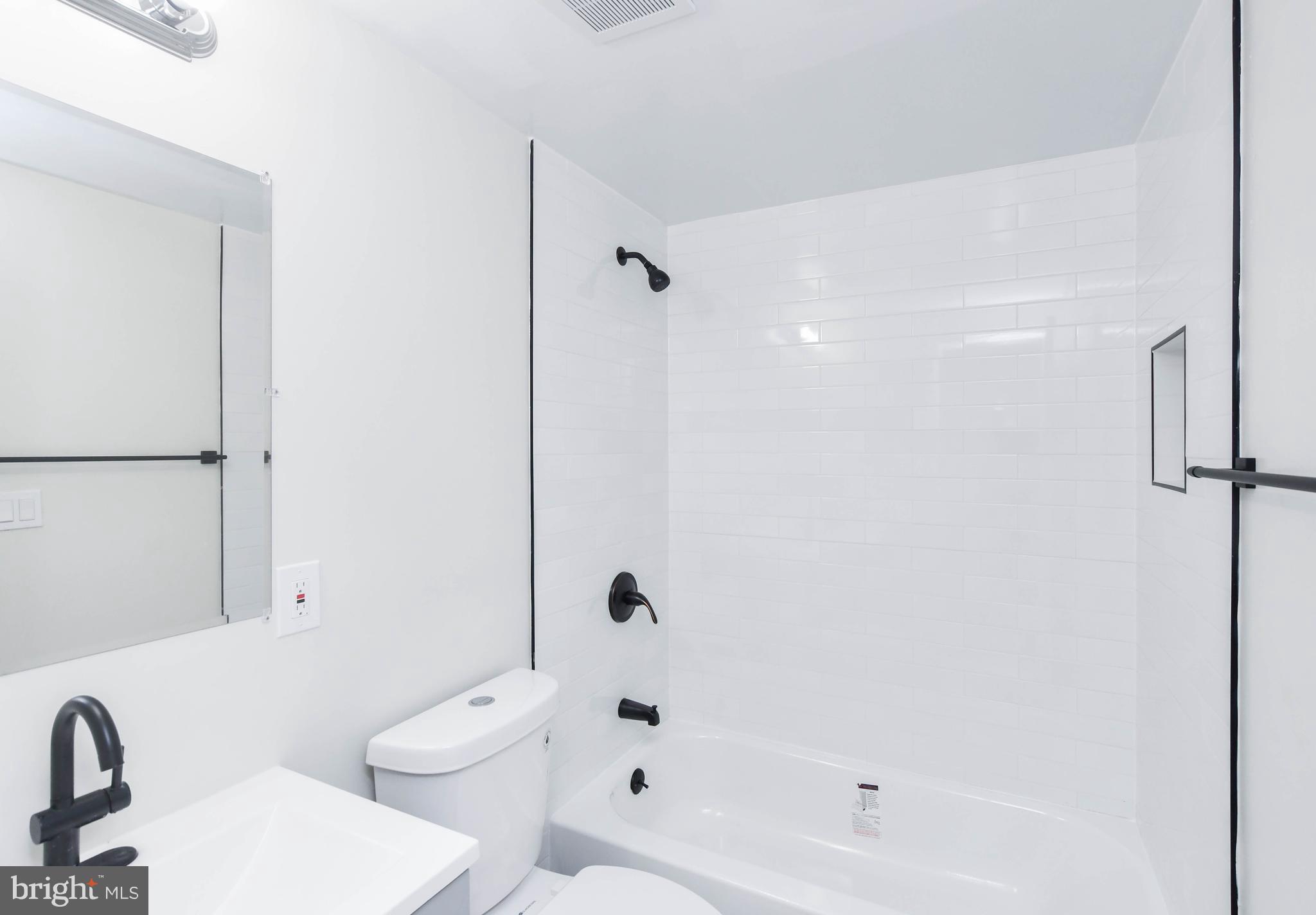 8130 Sheriff Road Landover, MD 20785 - Photo 27 of 36 a bathroom with a bathtub shower sink mirror and toilet