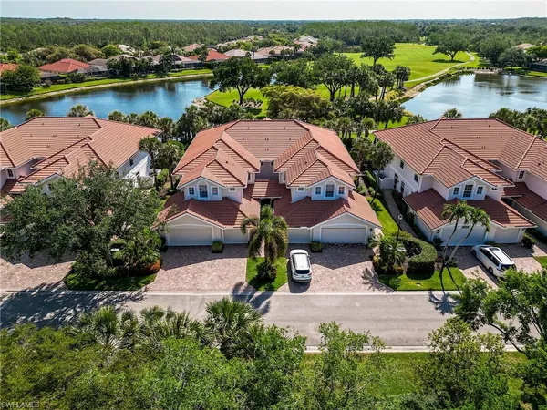 an aerial view of house with yard and lake view