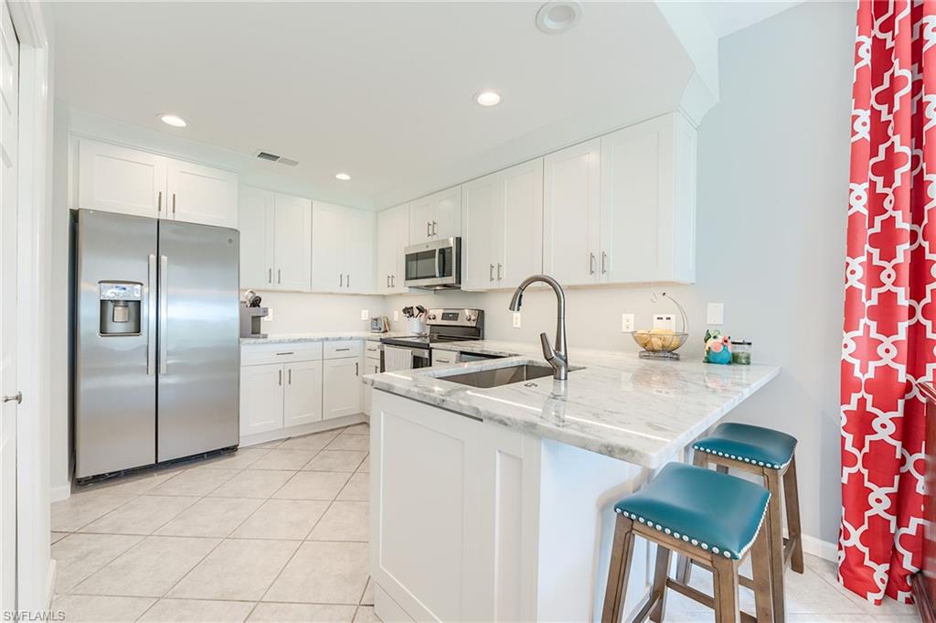 22971 Rosedale Drive, Unit 101 Estero, FL 34135 - Photo 4 of 43 NEW SHAKER CABINETRY WITH QUARTZ COUNTERTOPS, NEW LIGHTING AND NEW PLUMBING FIXTURES, AND STAINLESS STEEL APPLIANCES