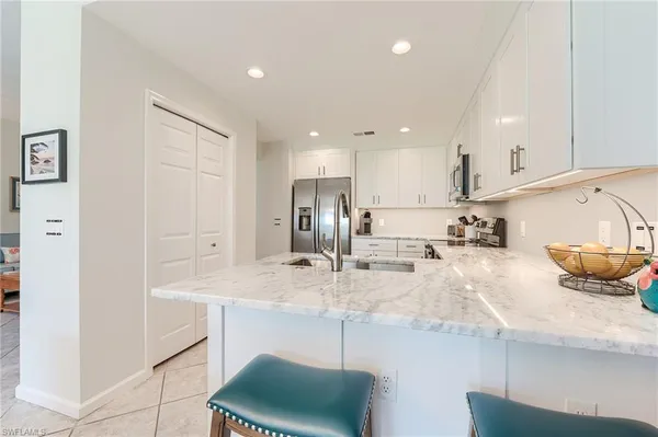 a kitchen with stainless steel appliances granite countertop a sink and cabinets