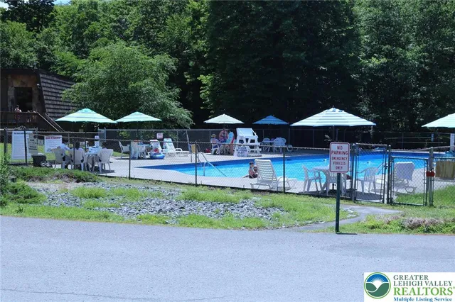 a patio with a table and chairs under an umbrella