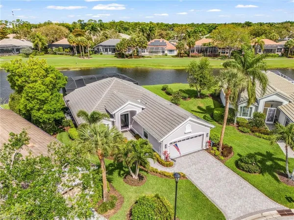 an aerial view of a house with a garden and lake view