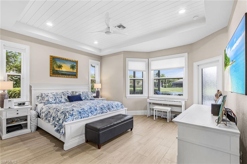 1799 Langford Lane Naples, FL 34109 - Photo 13 of 25 a bedroom with a large bed and a couch