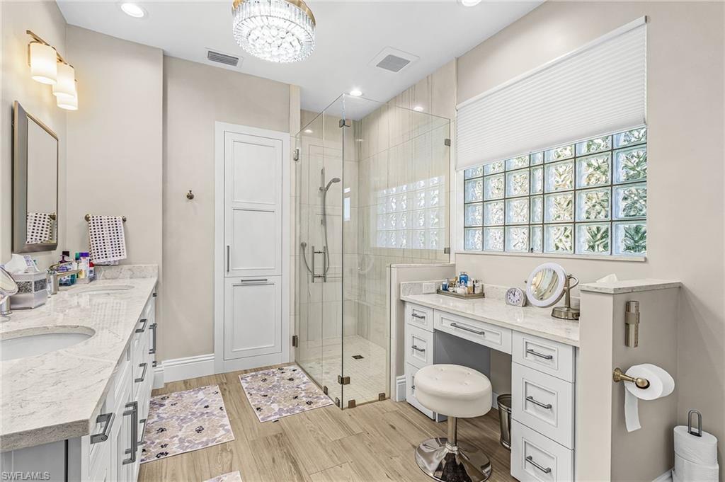 1799 Langford Lane Naples, FL 34109 - Photo 14 of 25 a spacious bathroom with a granite countertop sink a toilet a shower and a mirror