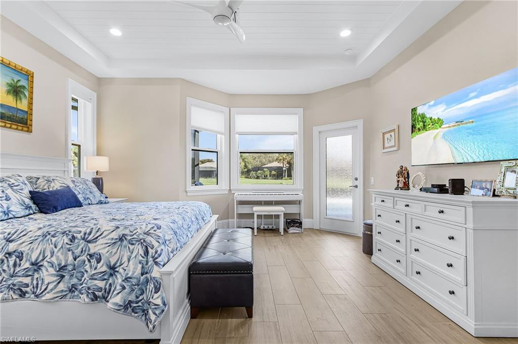 1799 Langford Lane Naples, FL 34109 - Photo 15 of 25 a bedroom with a bed and wooden floor