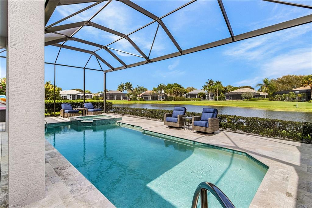 1799 Langford Lane Naples, FL 34109 - Photo 17 of 25 a view of a swimming pool with a patio