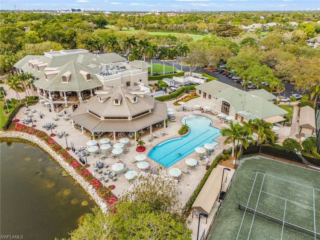 1799 Langford Lane Naples, FL 34109 - Photo 21 of 25 a view of a swimming pool with a table and chairs