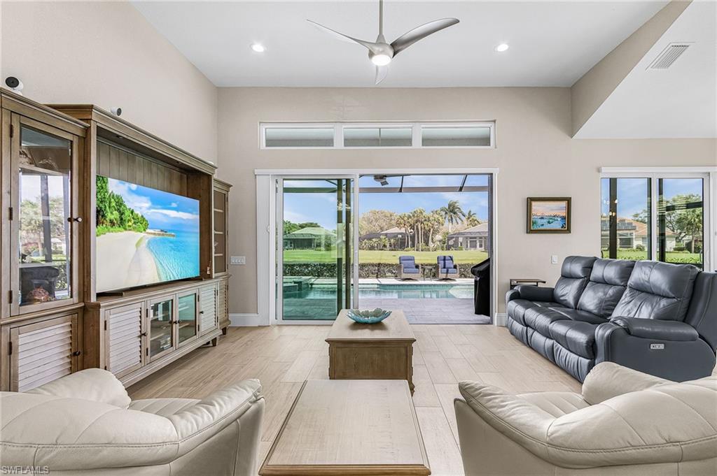 1799 Langford Lane Naples, FL 34109 - Photo 7 of 25 a living room with furniture and a flat screen tv