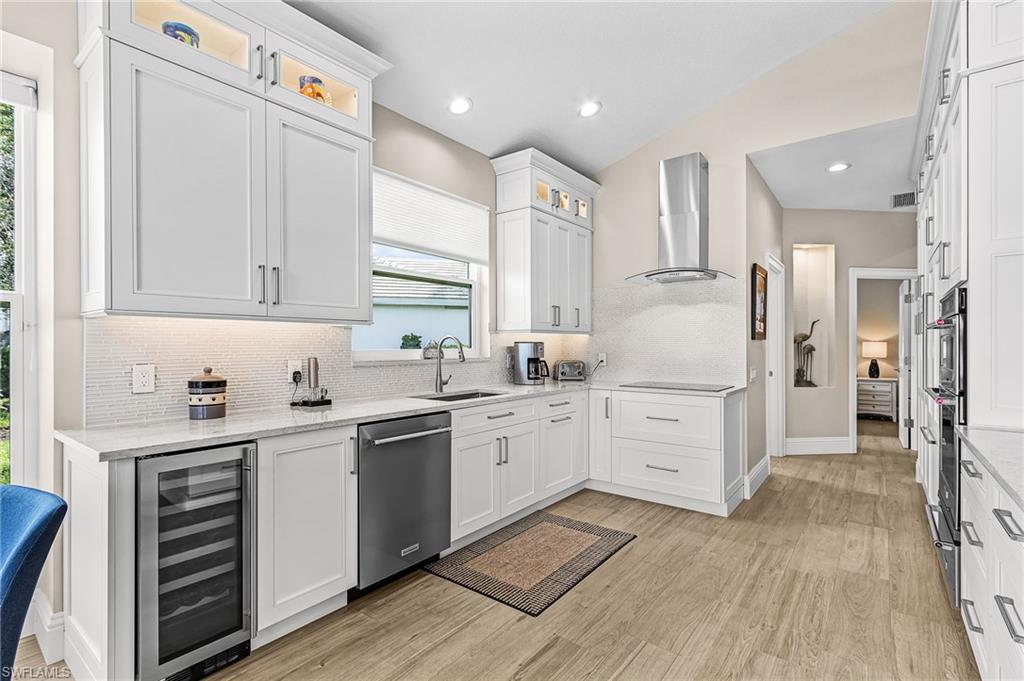 1799 Langford Lane Naples, FL 34109 - Photo 9 of 25 a kitchen with white cabinets and white appliances