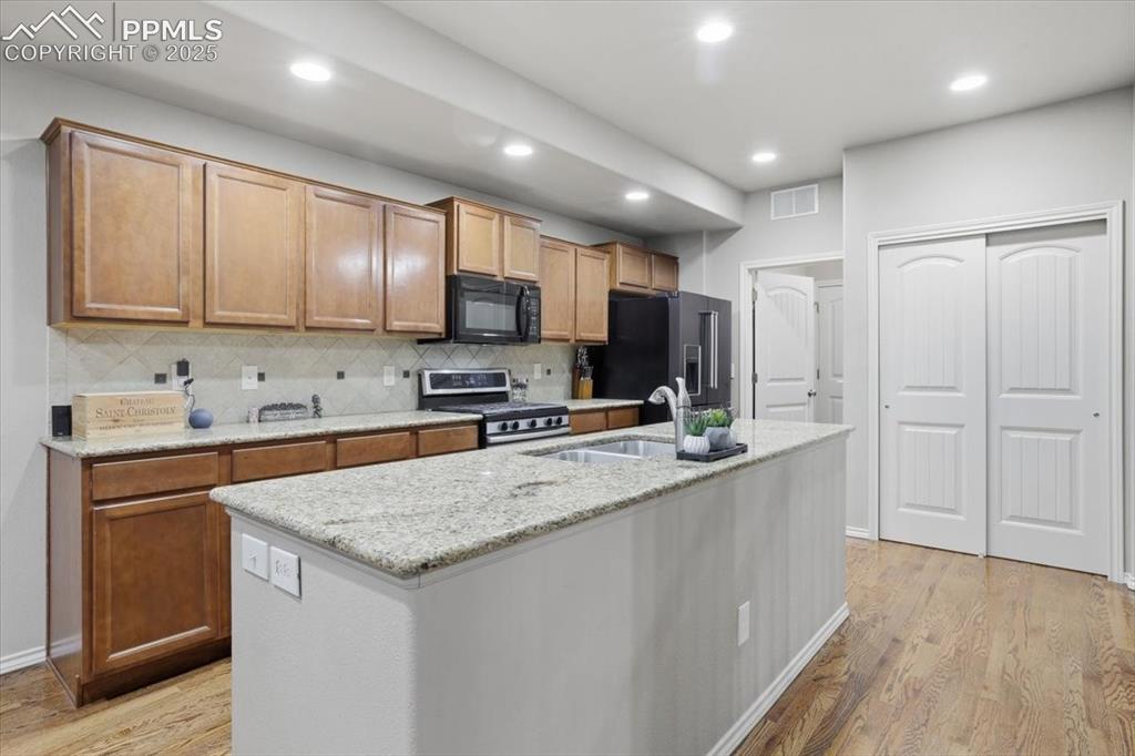 2374 Cinnabar Road Colorado Springs, CO 80921 - Photo 19 of 47 Granite countertops, a tile backsplace and an undermount sink make this kitchen easy to enjoy!