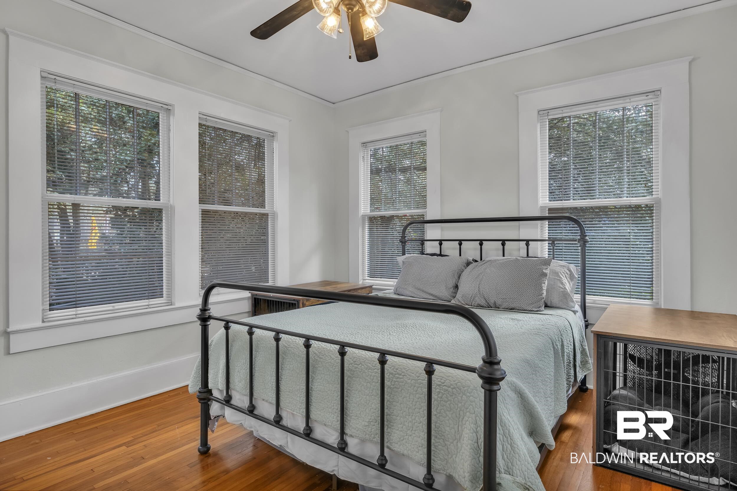 55 Mohawk Street Mobile, AL 36606 - Photo 19 of 28 Bedroom featuring baseboards, multiple windows, and wood finished floors