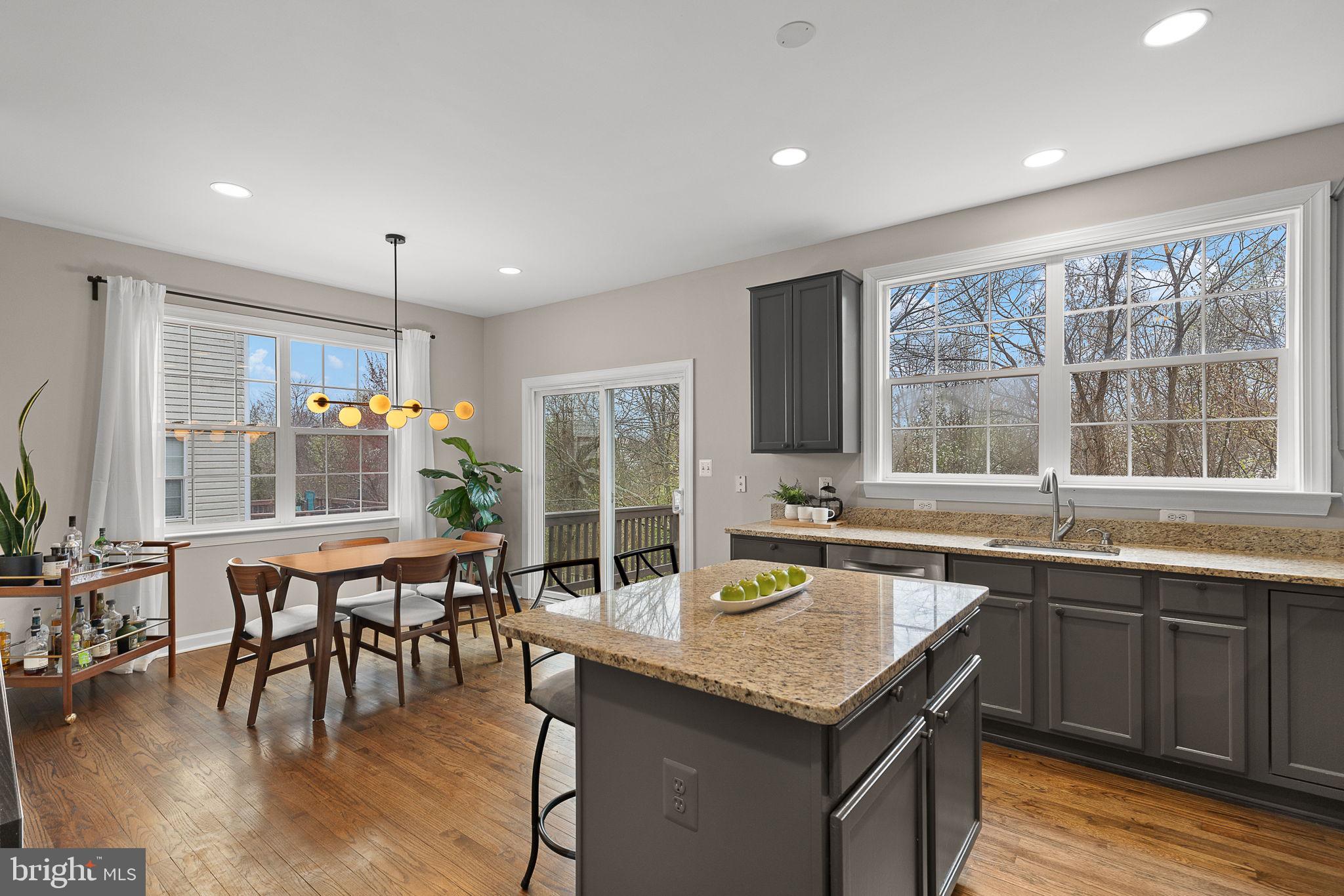 15686 Avocet Loop Woodbridge, VA 22191 - Photo 11 of 33 a kitchen with a table chairs and wooden floor