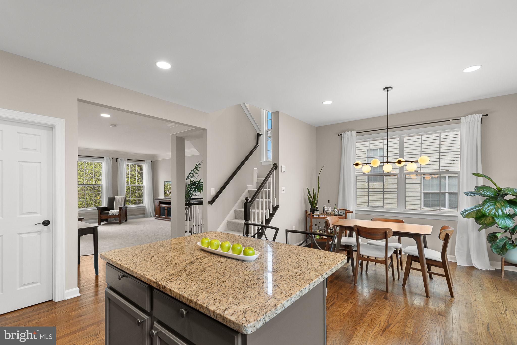 15686 Avocet Loop Woodbridge, VA 22191 - Photo 12 of 33 a kitchen with stainless steel appliances granite countertop counter space dining table and wooden floor