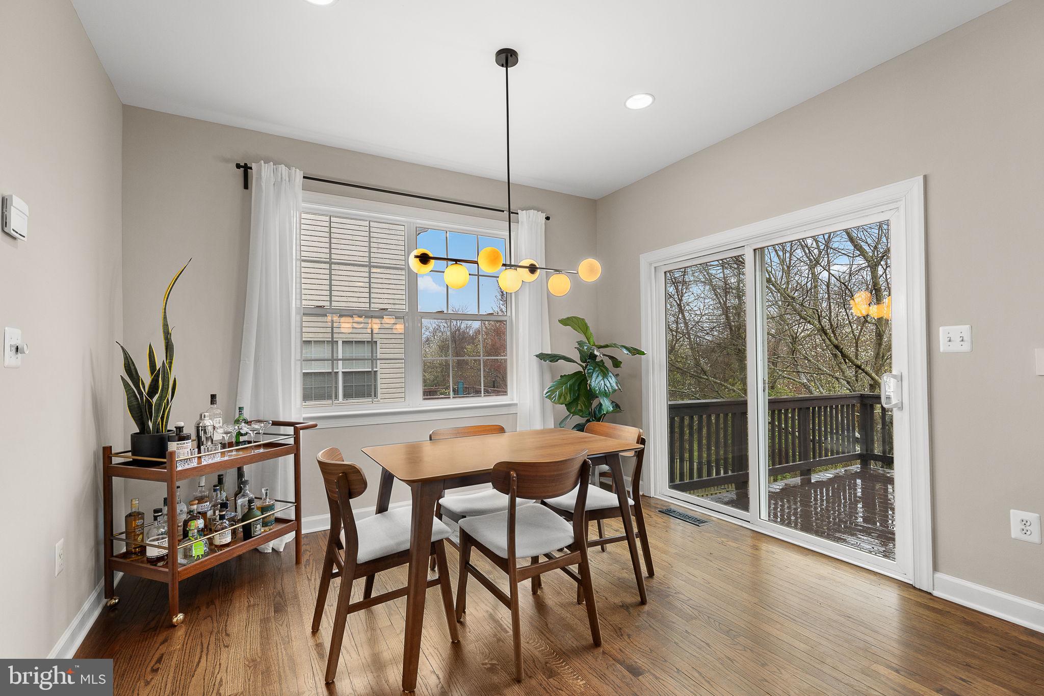 15686 Avocet Loop Woodbridge, VA 22191 - Photo 13 of 33 a dining room with furniture large windows and wooden floor
