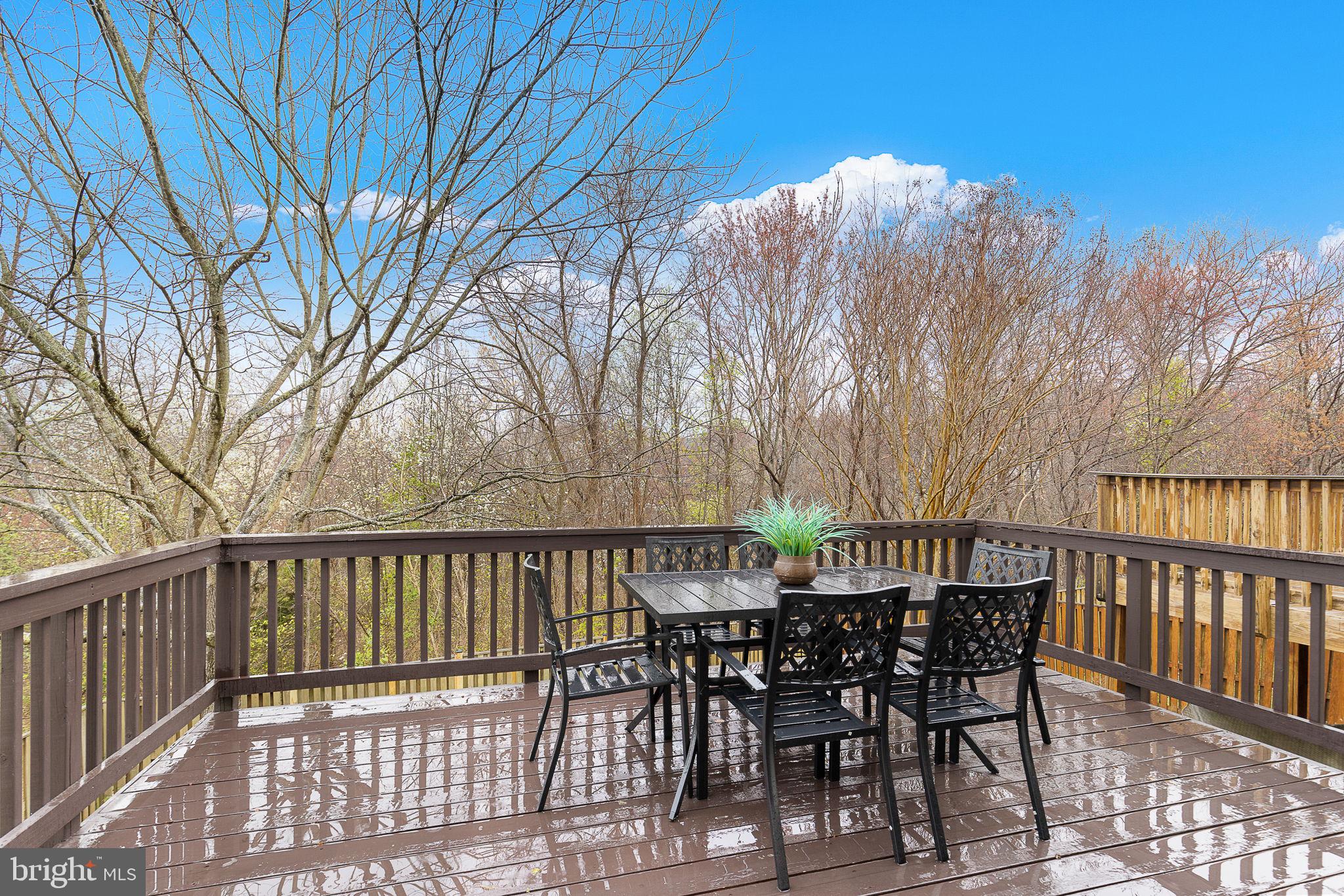 15686 Avocet Loop Woodbridge, VA 22191 - Photo 14 of 33 a view of a roof deck with table and chairs and wooden floor