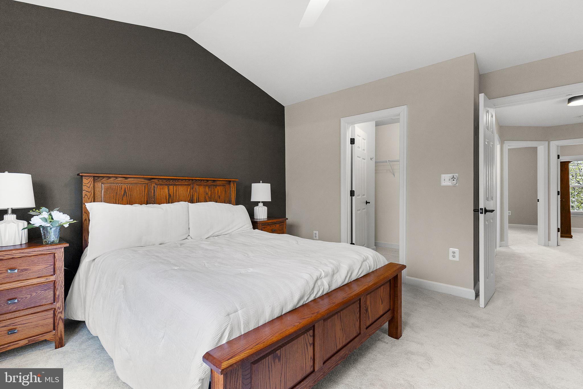 15686 Avocet Loop Woodbridge, VA 22191 - Photo 17 of 33 a bed sitting in a bedroom and a lamp