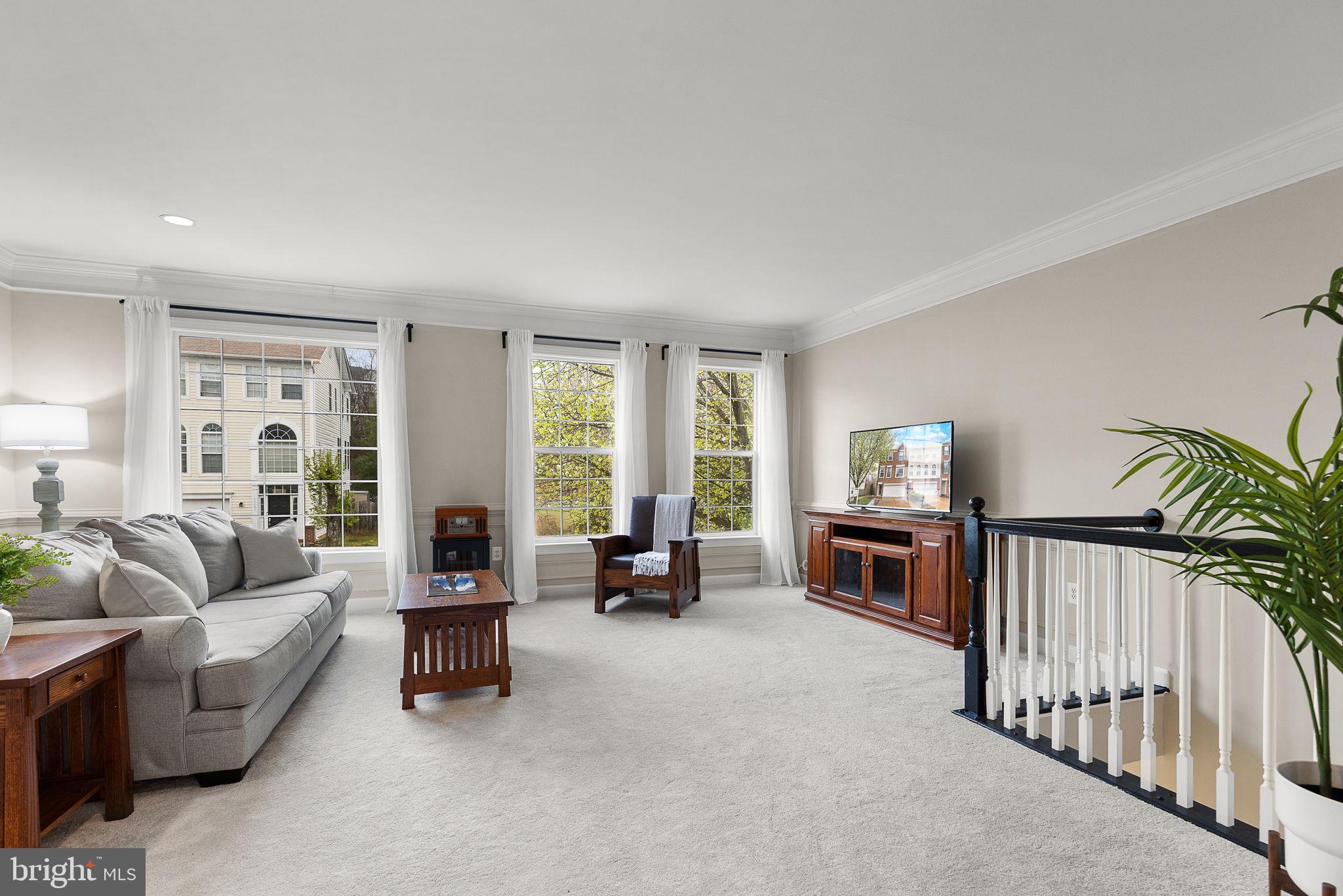 15686 Avocet Loop Woodbridge, VA 22191 - Photo 2 of 33 a living room with furniture and a flat screen tv