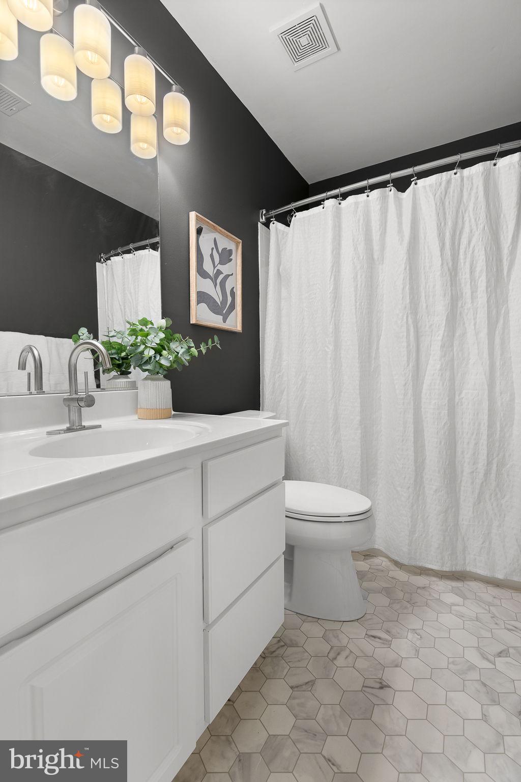 15686 Avocet Loop Woodbridge, VA 22191 - Photo 25 of 33 a bathroom with a toilet sink and mirror