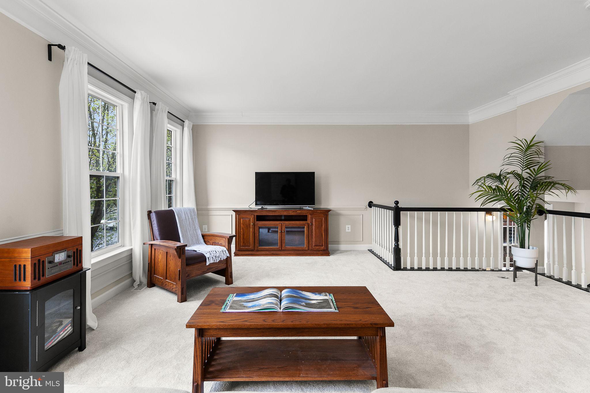 15686 Avocet Loop Woodbridge, VA 22191 - Photo 5 of 33 a living room with furniture a flat screen tv and a fireplace