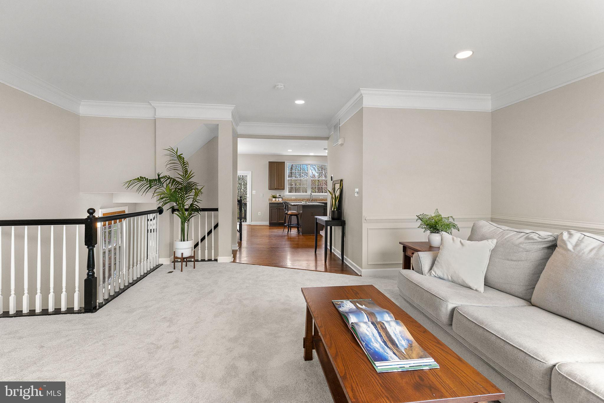 15686 Avocet Loop Woodbridge, VA 22191 - Photo 7 of 33 a living room with furniture and a dining table with potted plant