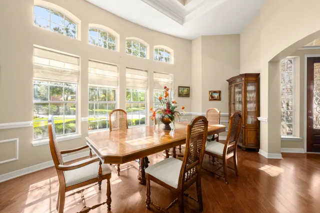a dining room with furniture and wooden floor