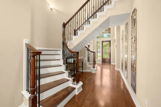 a view of entryway and hall with wooden floor