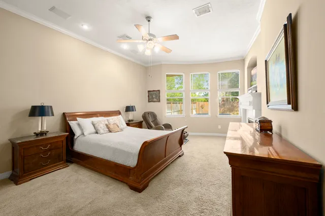 a bedroom with a large bed and a chandelier