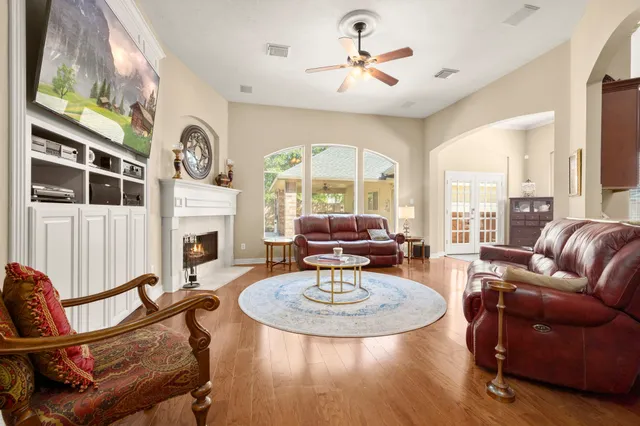 a living room with furniture a large window and a fireplace