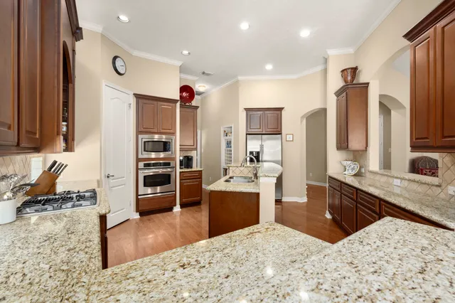 a kitchen with a sink stove and cabinets