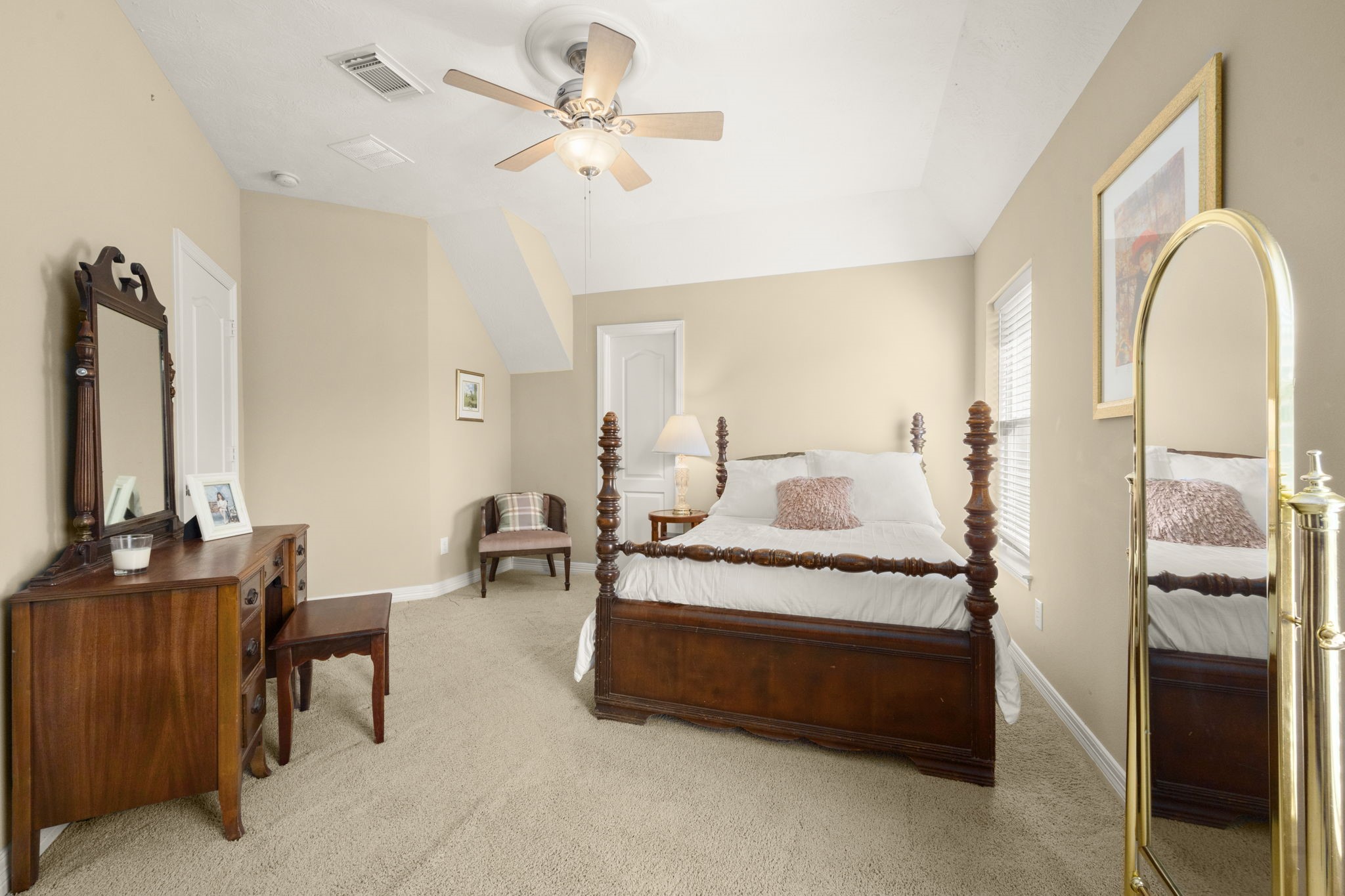 19902 Tidy Tips Lane Spring, TX 77379 - Photo 26 of 50 a spacious bedroom with a bed a couch and a chandelier