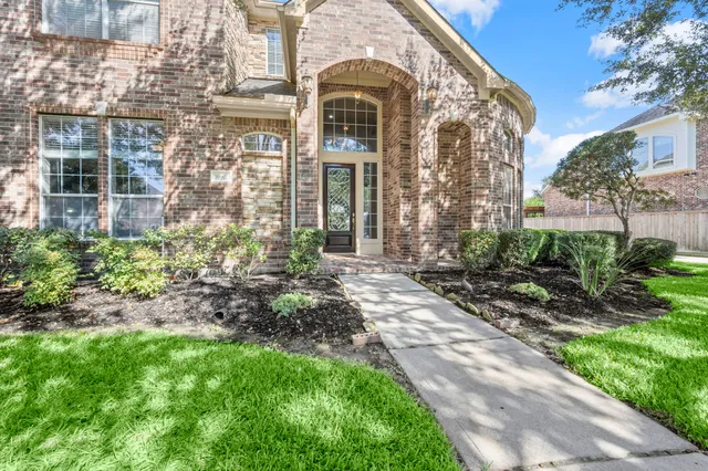 a view of a patio with table and chairs with wooden floor and fence