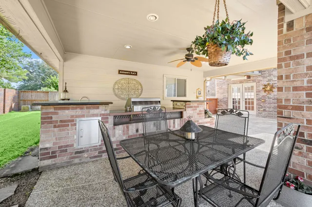 a view of a backyard with plants and outdoor seating