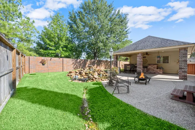 an aerial view of a house with a garden and trees